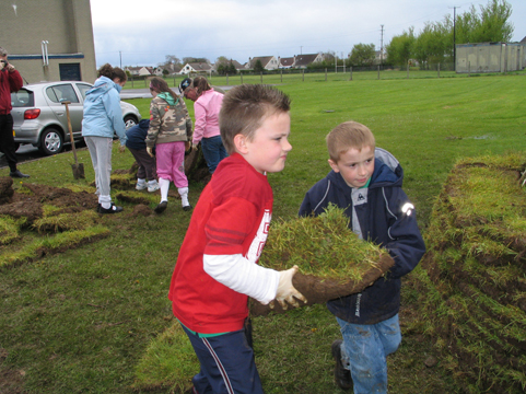 Building a Mesolithic hut. St Malachy's pupils start to build up the walls.